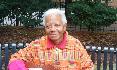 Ella Jenkins playing a guitar