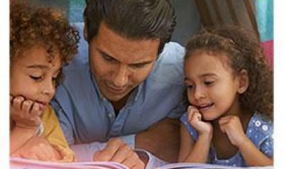 Father reading to son and daughter