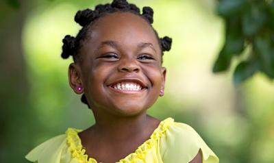 Preschool girl smiling outside