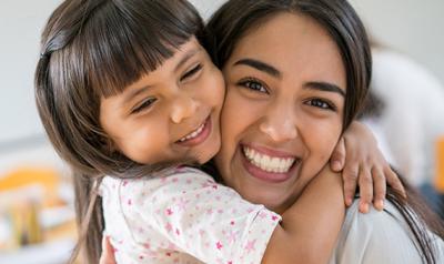 Mother and daughter hugging