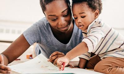 Toddler and mother reading a book 