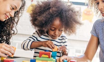 Young girl plays with blocks.
