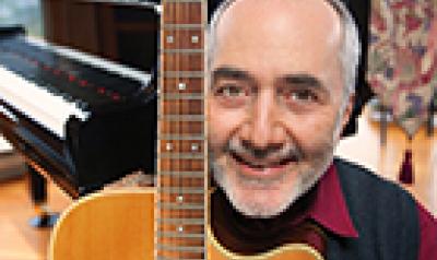 Raffi holding a guitar