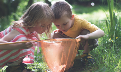 Two children playing outdoors 