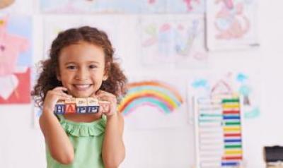 preschool girl holding blocks