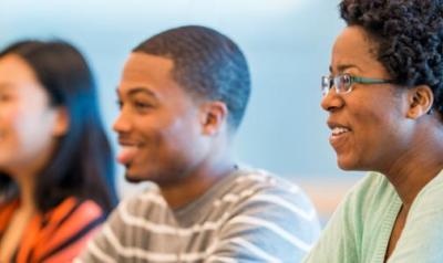 Three students in a higher education classroom