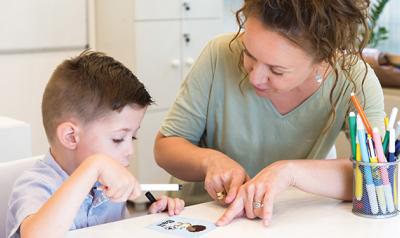 teacher showing student a picture