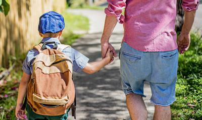 Father and son holding hands outside 