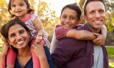 Family of four walking outside together