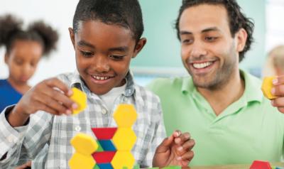Teacher observing a child build a toy structure