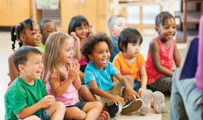 Preschool students sitting on floor