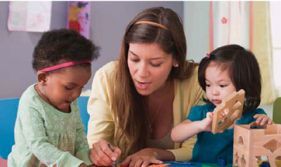 Teacher helping two students