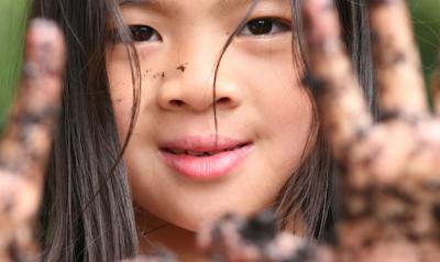 Girl with mud on hands