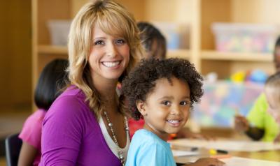 Teacher sitting with preschooler