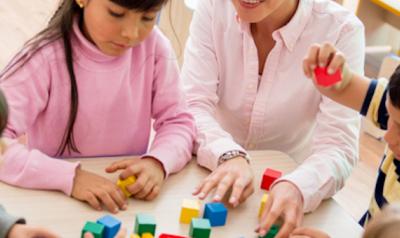 Teacher and children playing with blocks