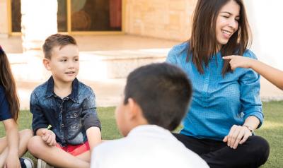 Teacher and students sitting in a circle