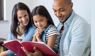 family of 3 reading a book