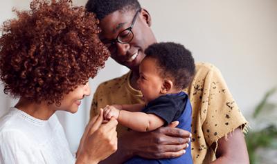 A couple playing with a toddler 