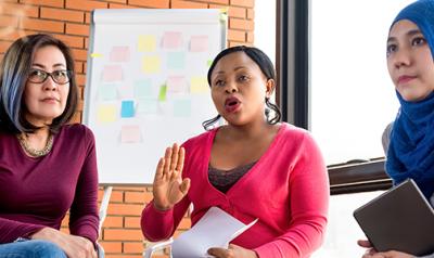 A group of women engaged a round table discussion. 