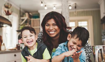 mother hugging two sons in the kitchen