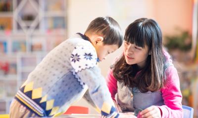 Two children working on a project in their classroom