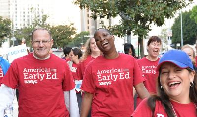 A group of early education advocates walking down the street