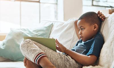 Child reading a book at home