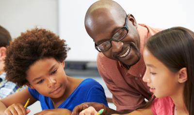 a teacher overseeing two children