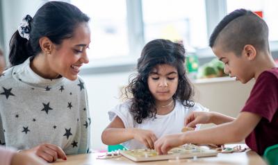 young children doing a puzzle game at a table