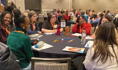 conference attendees discussing something at a table