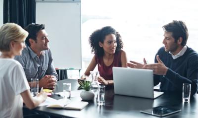 professionals discussing something at a conference table