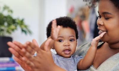 a parent and child clapping together