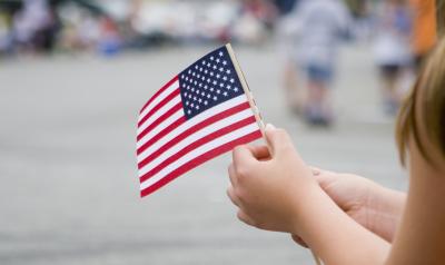 a child holding an american flag
