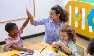 a teacher giving a child a high five