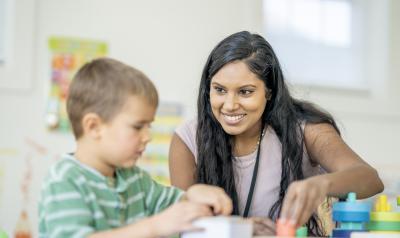 A teacher helping a student in the classroom