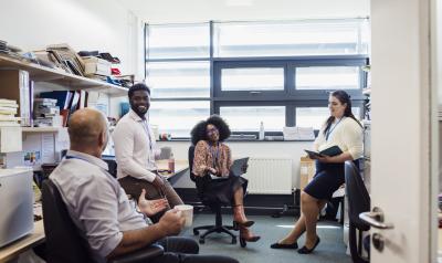 Teachers meeting with each other in the break room