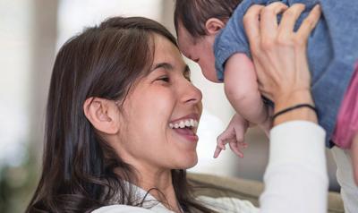 Mother holding baby in air