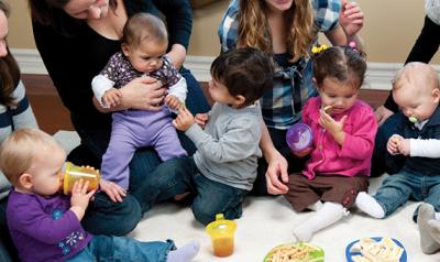 Parents sitting in half circle with toddler children