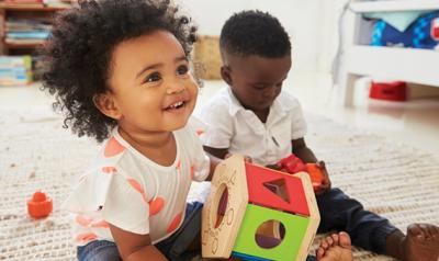 Two toddlers playing with toys