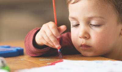 Boy holding a paintbrush