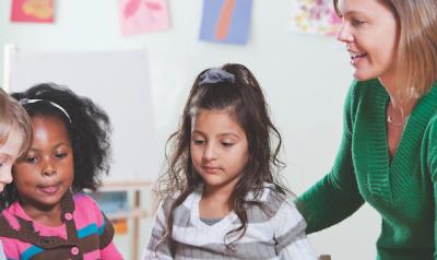 Teacher observing three students 