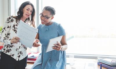 Two teachers reviewing documents