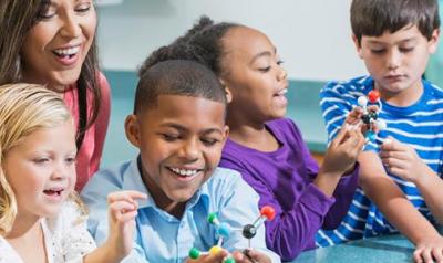 Teacher in a classroom with 4 diverse children