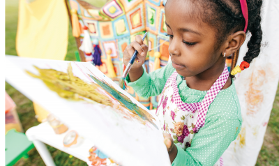 Girl painting on a canvas