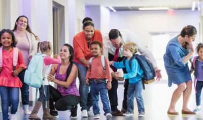 Young children leaving their teachers and classrooms