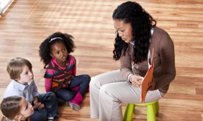 young students listen to teacher tell a story