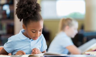 A young child reading a book.