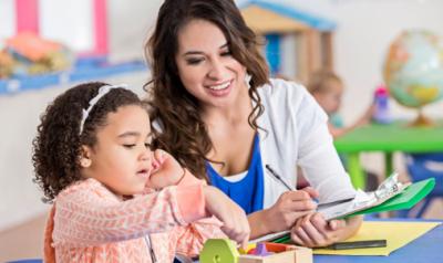 a teacher observing a child using toys