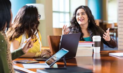 Professionals discussing their early learning program at a conference table.