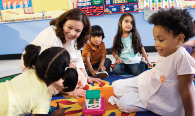 A teacher and her students playing